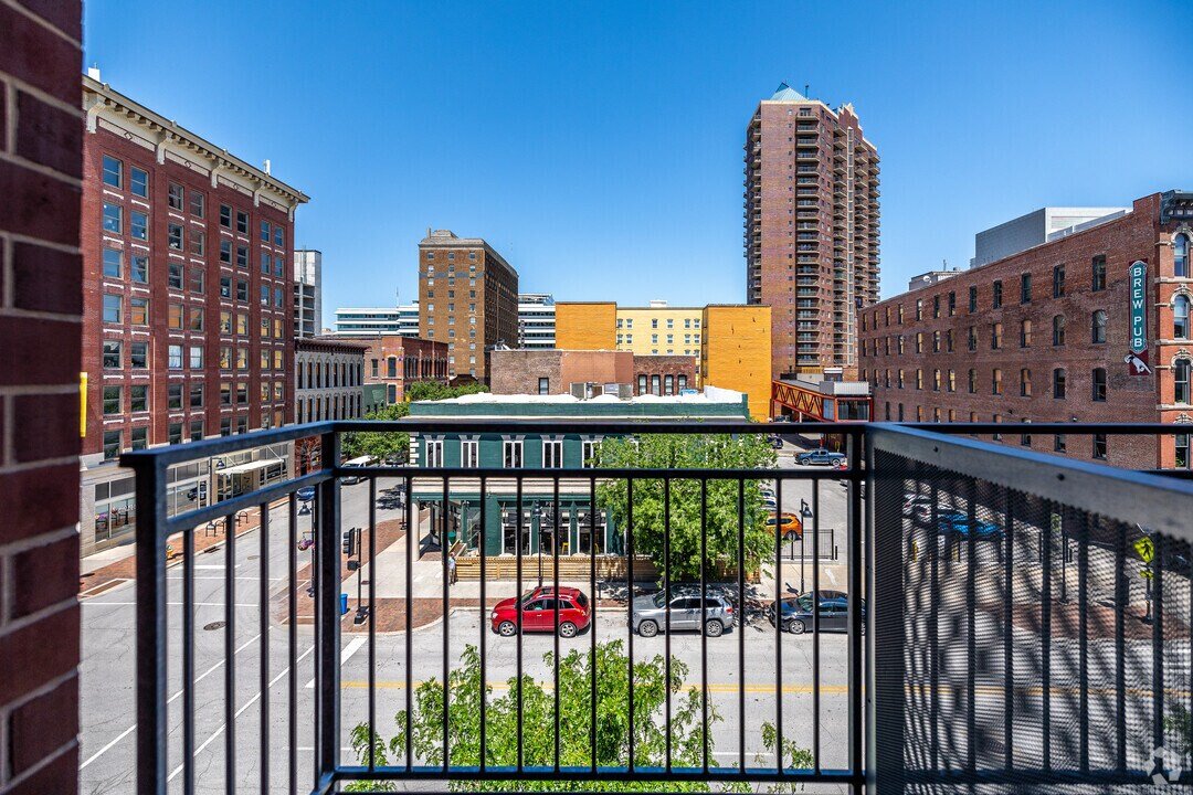 View from a unit balcony looking down onto Court Avenue's restaurants, bars, and street parking