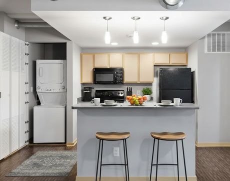 A kitchen with a breakfast bar and stool seating