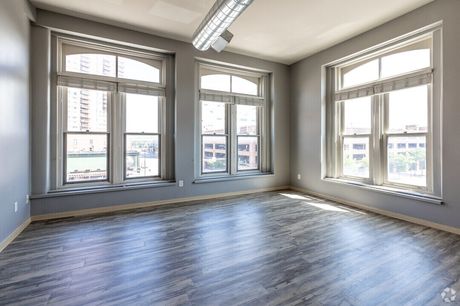 A living room with tall arched windows